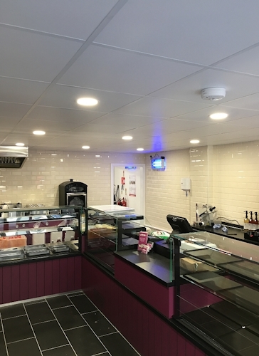 Inside a bakery shop with a white hygienic suspended ceiling.